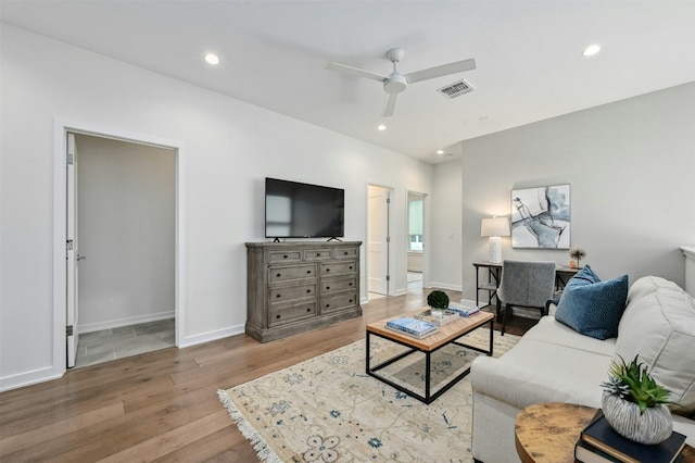 living room featuring ceiling fan and light hardwood / wood-style floors