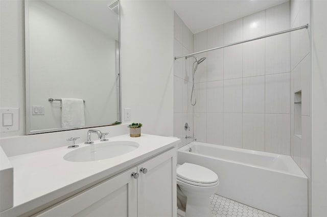 full bathroom with vanity, tile patterned flooring, toilet, and tiled shower / bath