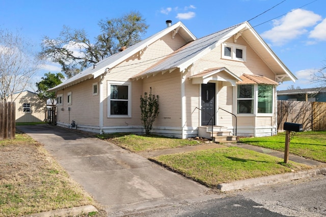 bungalow-style house with a front lawn