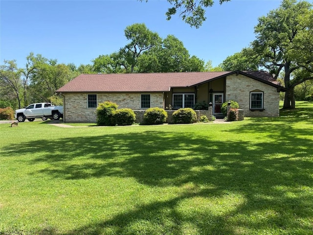 view of front of property with a front lawn and stone siding