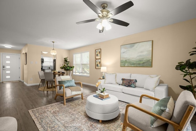 living room featuring dark hardwood / wood-style floors and ceiling fan