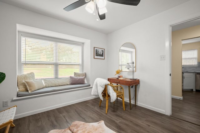 living area with dark wood-type flooring and ceiling fan