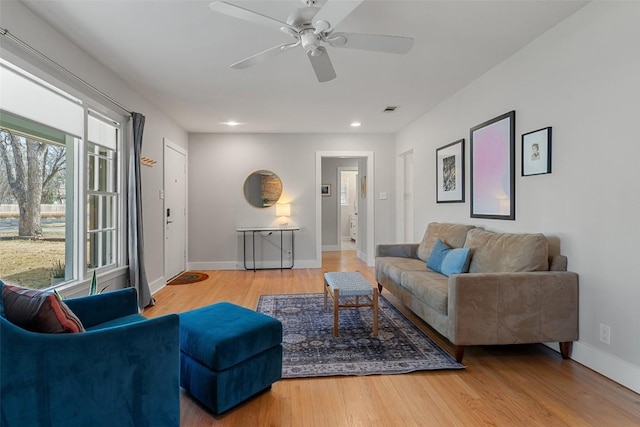 living room with hardwood / wood-style flooring and ceiling fan