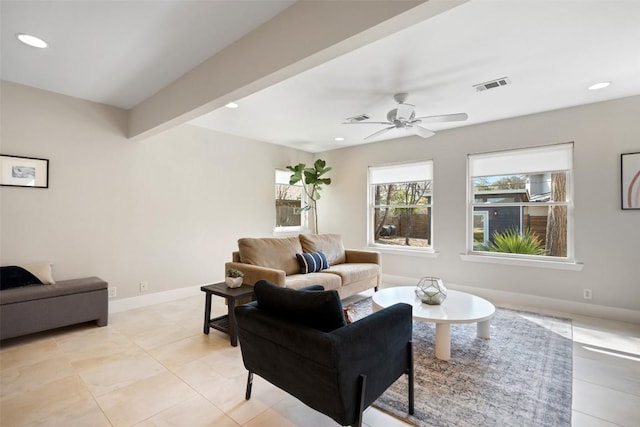 living room with light tile patterned flooring, ceiling fan, and beam ceiling