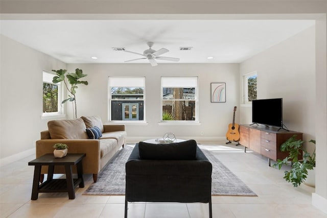 living room featuring light tile patterned floors and ceiling fan