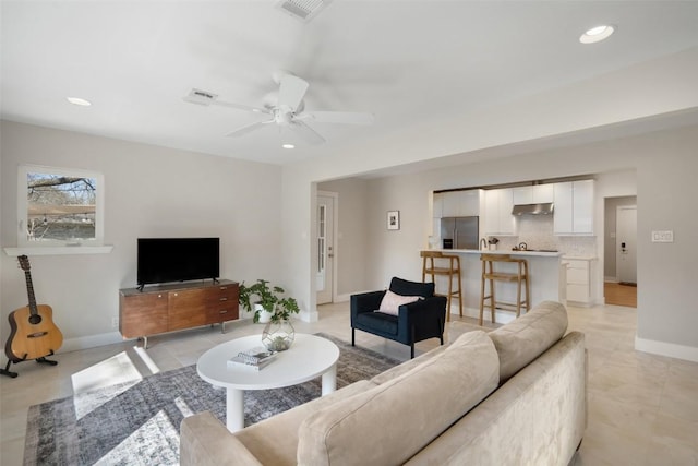 living room featuring ceiling fan and light tile patterned flooring