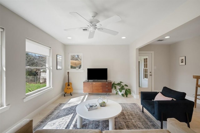 tiled living room with ceiling fan