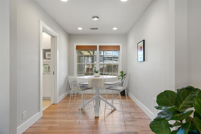 dining area with light hardwood / wood-style flooring