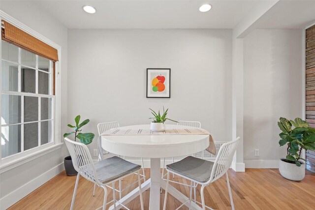 dining space with light hardwood / wood-style flooring