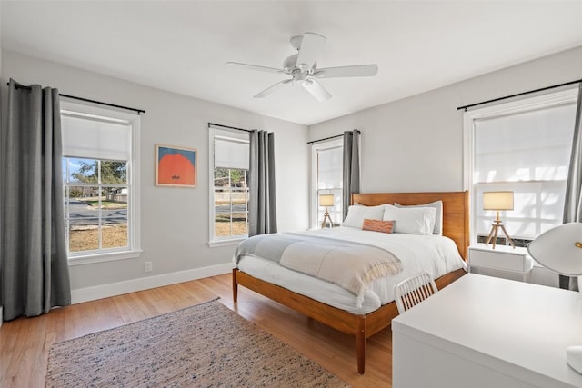 bedroom with ceiling fan and light wood-type flooring