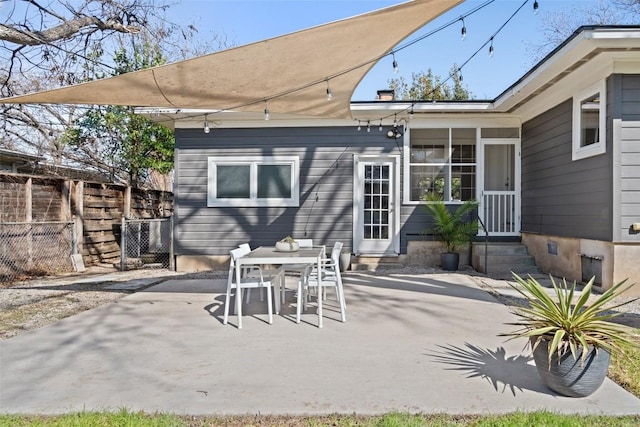 view of patio / terrace featuring a sunroom