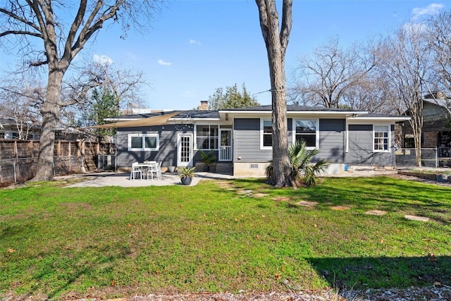 rear view of property with a patio area and a lawn