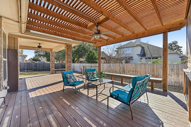 wooden deck featuring ceiling fan, a fenced backyard, and a pergola