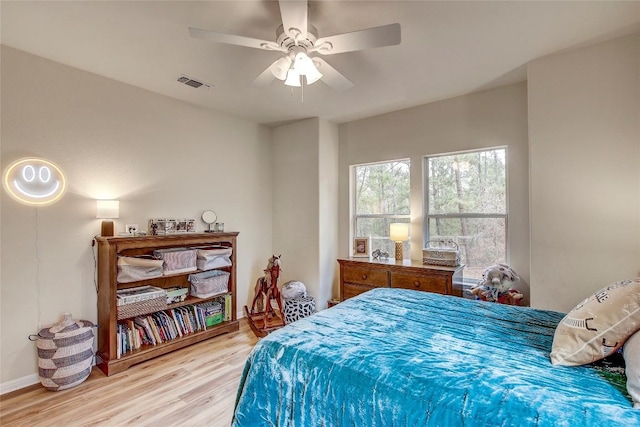 bedroom with light hardwood / wood-style flooring and ceiling fan