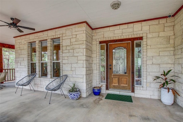 doorway to property with a porch and ceiling fan