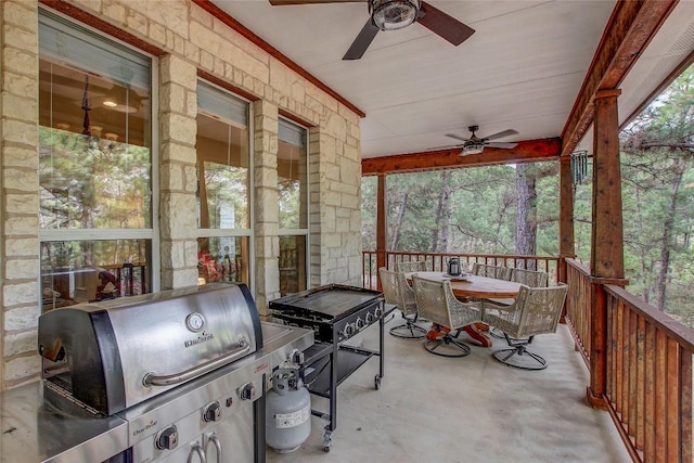 sunroom featuring ceiling fan