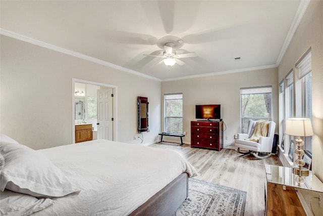 bedroom featuring multiple windows, ensuite bath, light hardwood / wood-style flooring, and ornamental molding