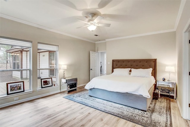 bedroom with crown molding, light hardwood / wood-style floors, and ceiling fan