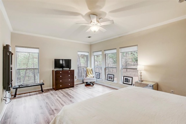 bedroom with crown molding, ceiling fan, and light hardwood / wood-style floors