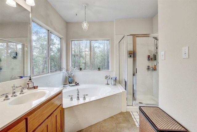 bathroom with tile patterned flooring, vanity, and independent shower and bath