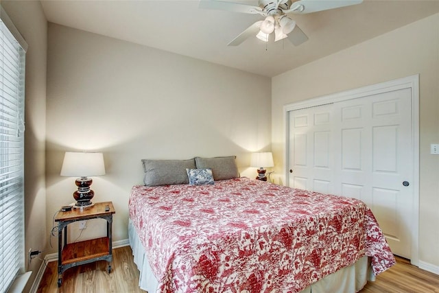 bedroom with ceiling fan, a closet, and light wood-type flooring