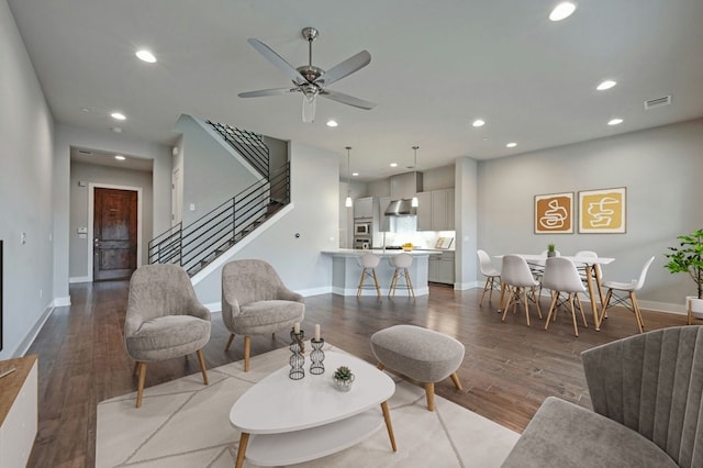 living room featuring ceiling fan and light hardwood / wood-style floors