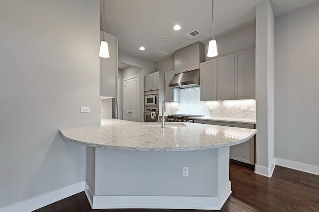 kitchen with sink, extractor fan, kitchen peninsula, pendant lighting, and backsplash