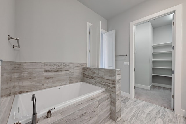 bathroom featuring a relaxing tiled tub