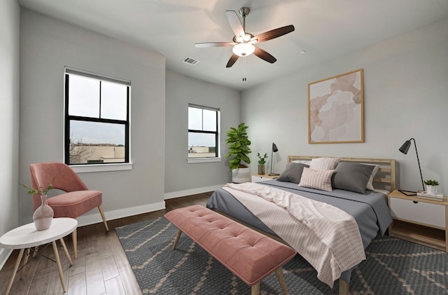 bedroom with dark wood-type flooring and ceiling fan