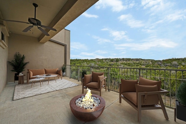 view of patio with a fire pit and ceiling fan