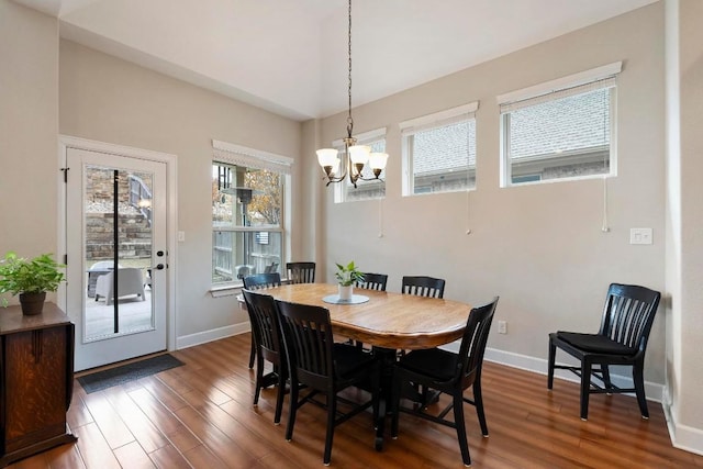 dining room featuring a notable chandelier and dark wood-type flooring