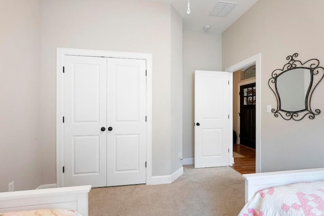 carpeted bedroom with a closet