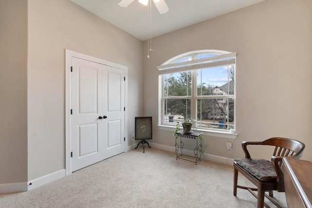 sitting room featuring light colored carpet and ceiling fan