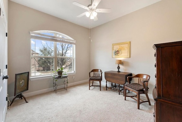 sitting room with ceiling fan and light carpet