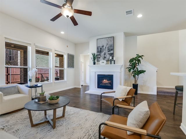 living room with ceiling fan and dark hardwood / wood-style floors