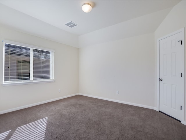 empty room with dark colored carpet