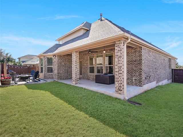 back of house with ceiling fan, a yard, and a patio area