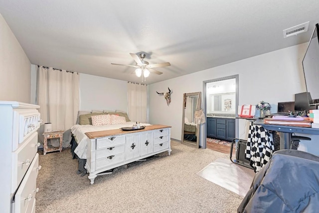 carpeted bedroom featuring ceiling fan and connected bathroom