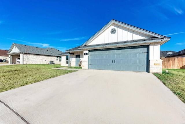 single story home with a garage and a front lawn