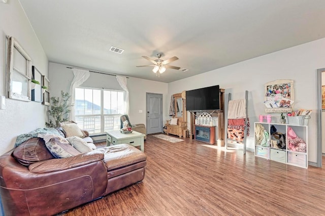 living room featuring ceiling fan and wood-type flooring