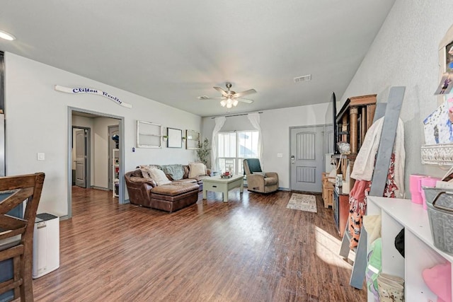 living room featuring dark hardwood / wood-style flooring and ceiling fan