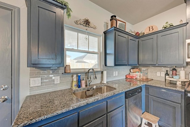 kitchen with stone countertops, sink, stainless steel dishwasher, and backsplash