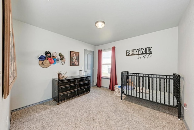 carpeted bedroom featuring a crib