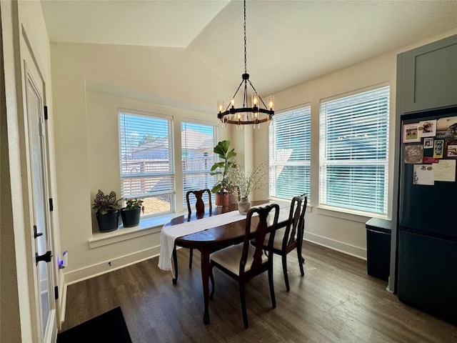 853 Cypress Ln, Cottonwood Shores, TX 78657 - dining area with a chandelier, dark wood-type flooring, baseboards, and vaulted ceiling