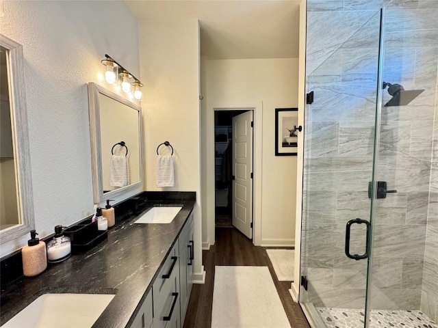 853 Cypress Ln, Cottonwood Shores, TX 78657 - full bath featuring wood finished floors, a stall shower, and double vanity