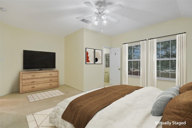 bedroom with ceiling fan, light colored carpet, and lofted ceiling