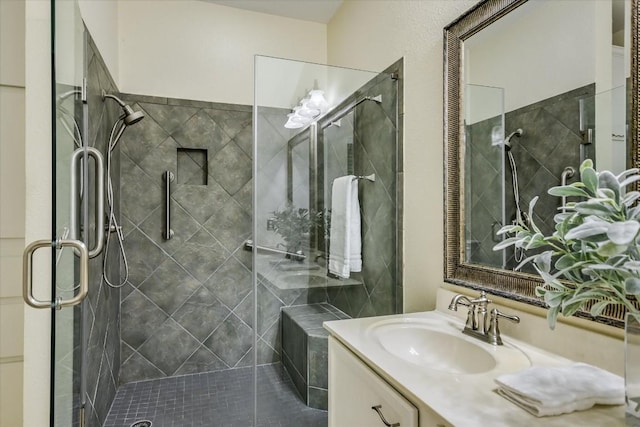 bathroom featuring vanity and a shower with door