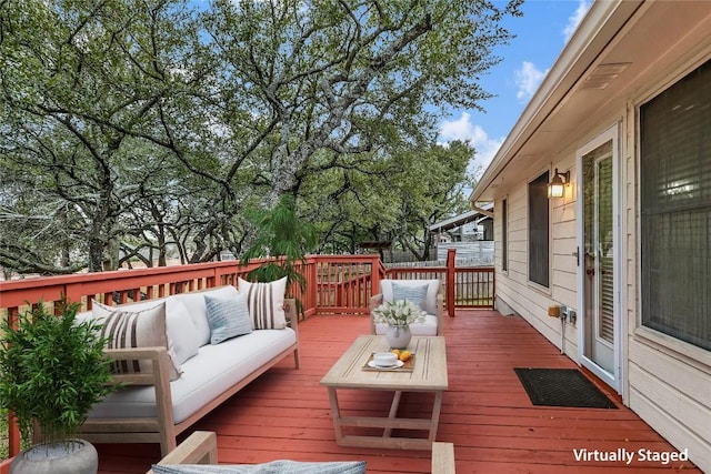 wooden deck with an outdoor living space