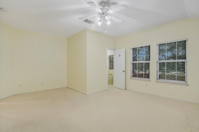 unfurnished room featuring ceiling fan, vaulted ceiling, and light carpet