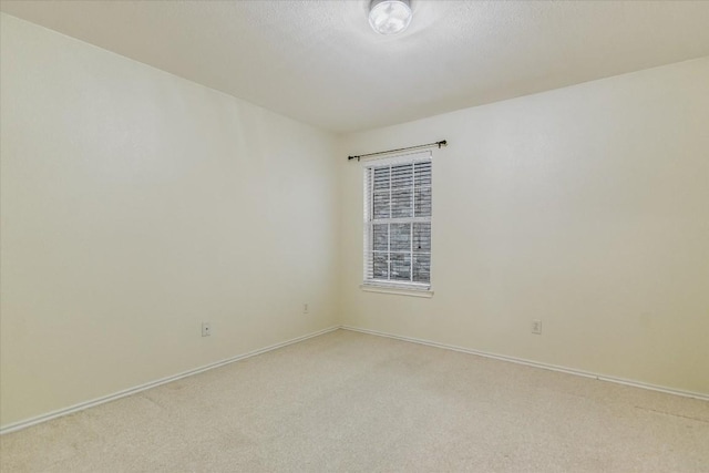 carpeted spare room featuring a textured ceiling